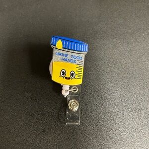 6 piece Lot of Fun Badge Reel with Urine Good Hands Design